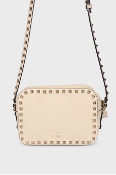 Milk-colored bag with spikes