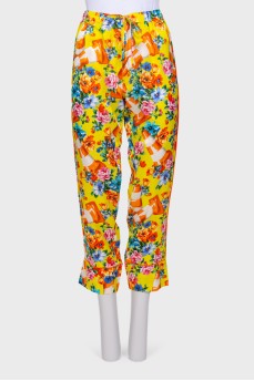 Yellow trousers with a floral print with label