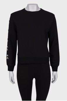 Black sweatshirt with patches on the sleeve