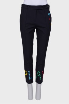 Blue trousers with colored eyelets