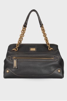 Black leather bag with golden hardware