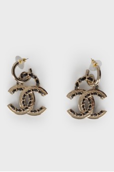 Silver earrings in the shape of the brand's logo