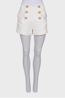 White shorts with golden buttons