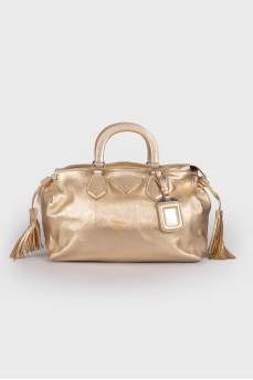 Golden bag with brand logo