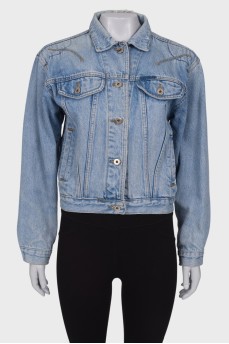 Denim jacket with a pattern on the back