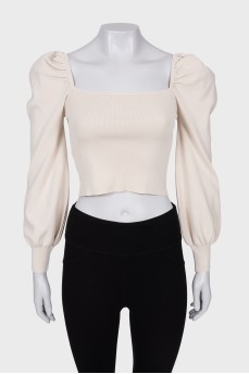 Knitted top with voluminous sleeves