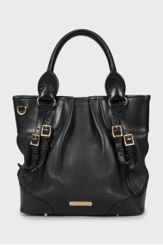 Leather bag decorated with clasps