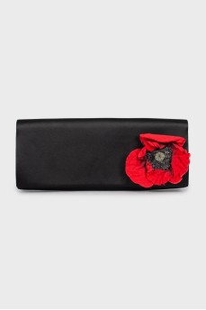 Black clutch decorated with a flower