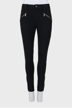 Black trousers decorated with zippers
