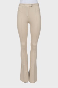 Beige flared trousers with stitched creases