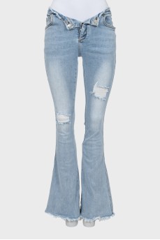Blue flared jeans with a distressed effect