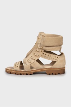 Suede sandals decorated with eyelet