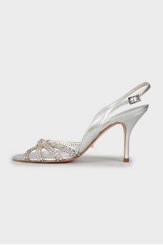 Silver sandals decorated with rhinestones