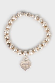 Silver bracelet with heart pendant