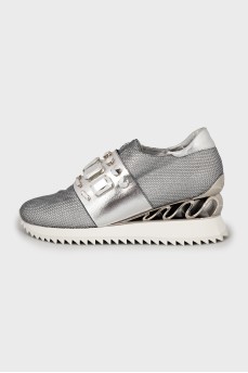 Silver sneakers decorated with rhinestones
