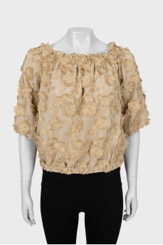 Blouse decorated with flowers and frills