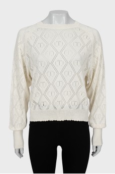 Knitted sweater with perforations