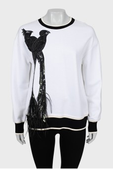 Sweatshirt decorated with sequins and feathers