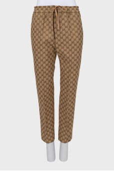 Men's trousers in branded print with tag