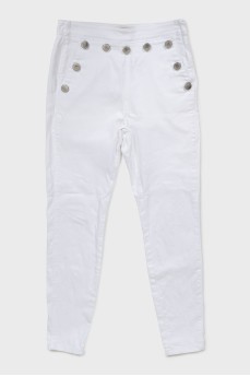 White jeans decorated with buttons