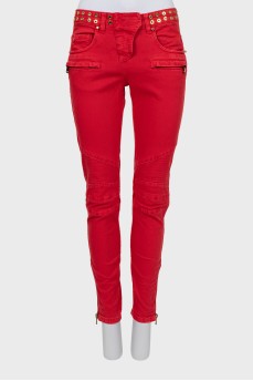 Red jeans decorated with eyelet