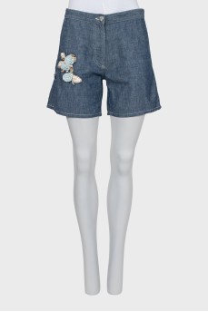 Denim shorts with patches and tag