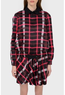 A jacket in an abstract checkered print with a tag