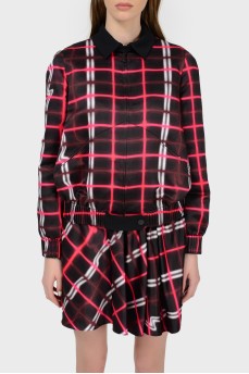 A jacket in an abstract checkered print with a tag