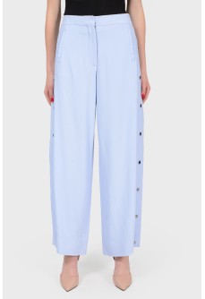 Blue free cut pants with buttons on the sides with a tag