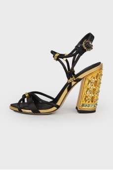 Black sandals with carved metal heels