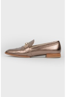 Gold colored loafers