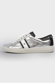 Silver sneakers decorated with stars