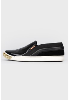 Black slip-ons with gold accents