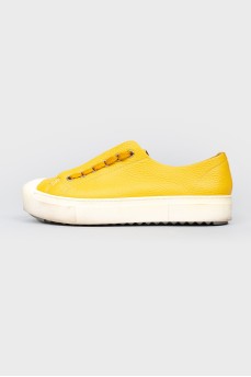 Yellow leather sneakers on lacing