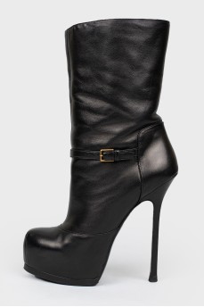 Black leather boots on a stiletto