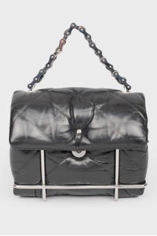 Black leather handbag with a metal base