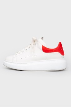 White leather sneakers with a red heel
