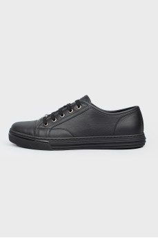 Black leather sneakers on lacing