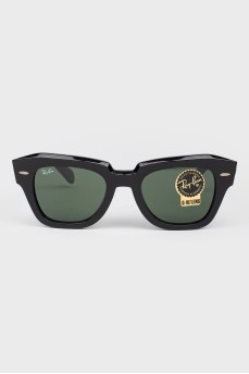 Rectangular black sunglasses with tag