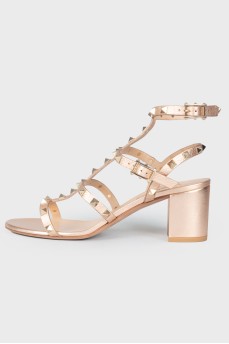 Rose gold color sandals with spikes