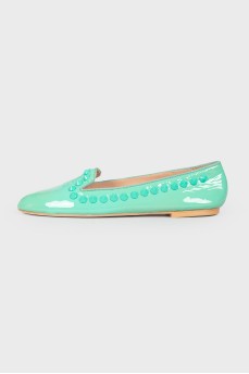 Green loafers with studs and tag