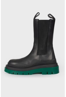Leather boots with green rubber sole