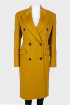 Mustard coat on a double -breasted fastener, with a tag