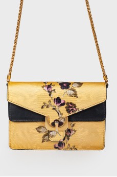 Golden bag with flowers