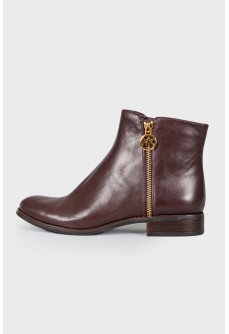 Leather boots with golden brand logo and tag