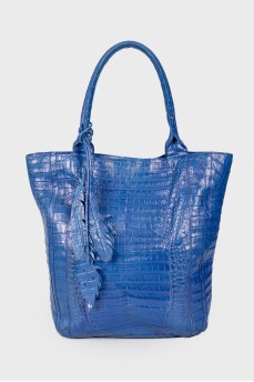 Blue bag with feather accessory