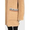 Reversible coat with knitted hood and tag