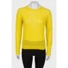 Translucent yellow sweater with a tag