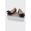 Black patent ballerinas with a large bow