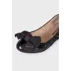 Black patent ballerinas with a large bow